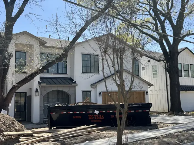Big Tejas dumpster loaded with construction and demolition debris at a DFW job site